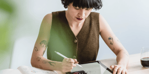 An artistic woman designing on her iPad.