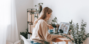 A woman working from home at her desk with her laptop. 