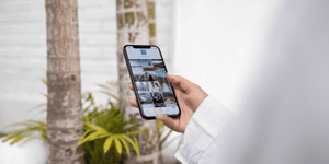 Person holding an iPhone looking at photos on Instagram.